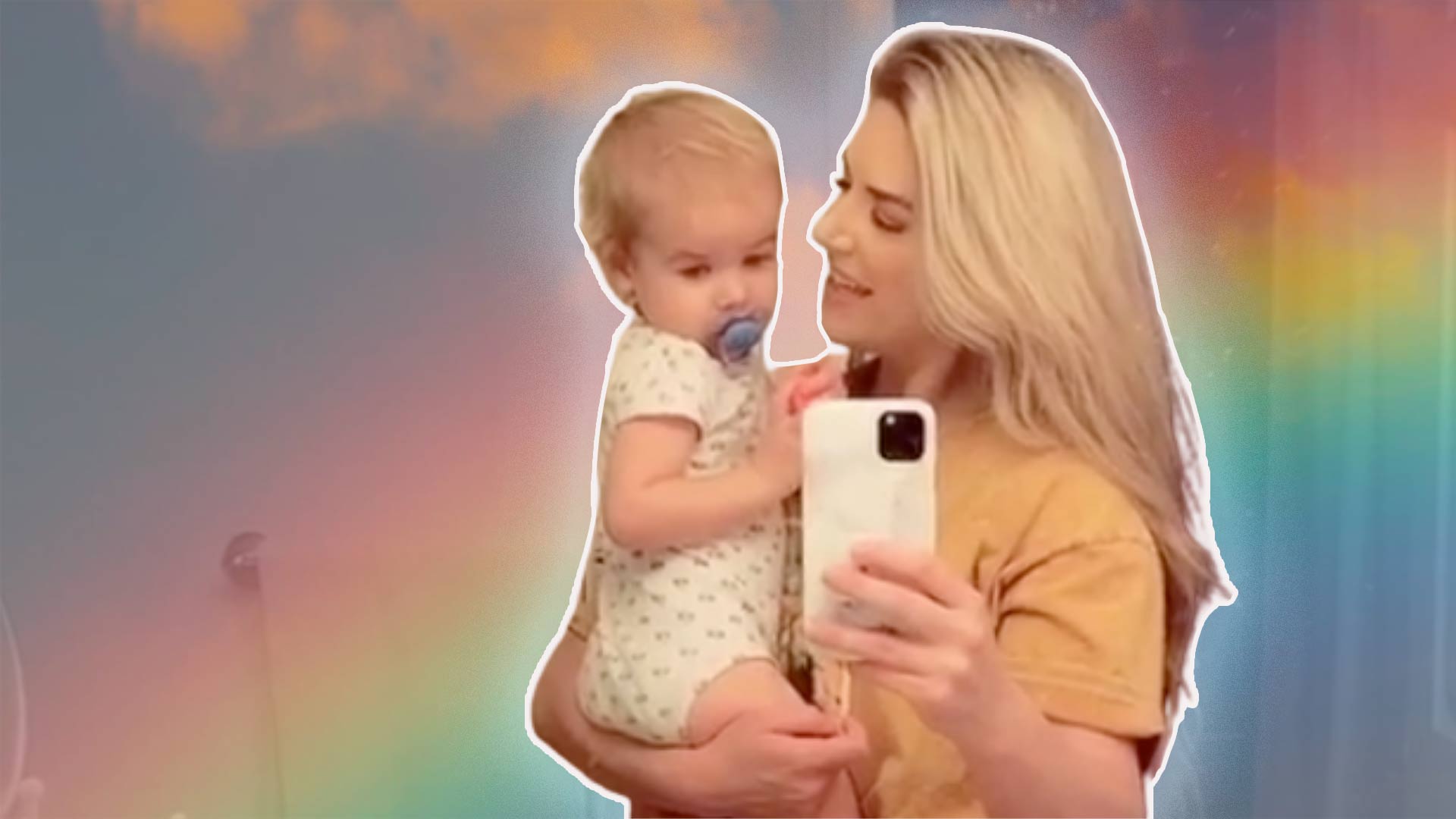 Mom Holds her Toddler on a rainbow background