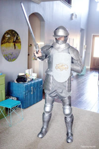 Person dressed in a suit of armor costume with a sword "Armor of God"
